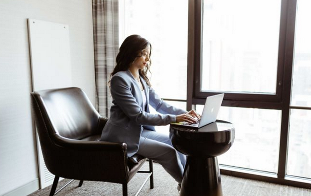 Guide: Business Access by Marriott Bonvoy - Business Access woman on laptop by a window